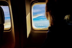 A woman looking out an aeroplane window