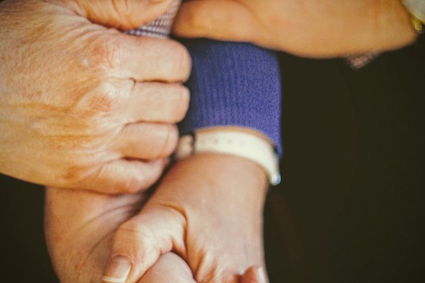 Hands from two generations, held together