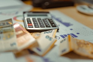A calculator among scattered banknotes